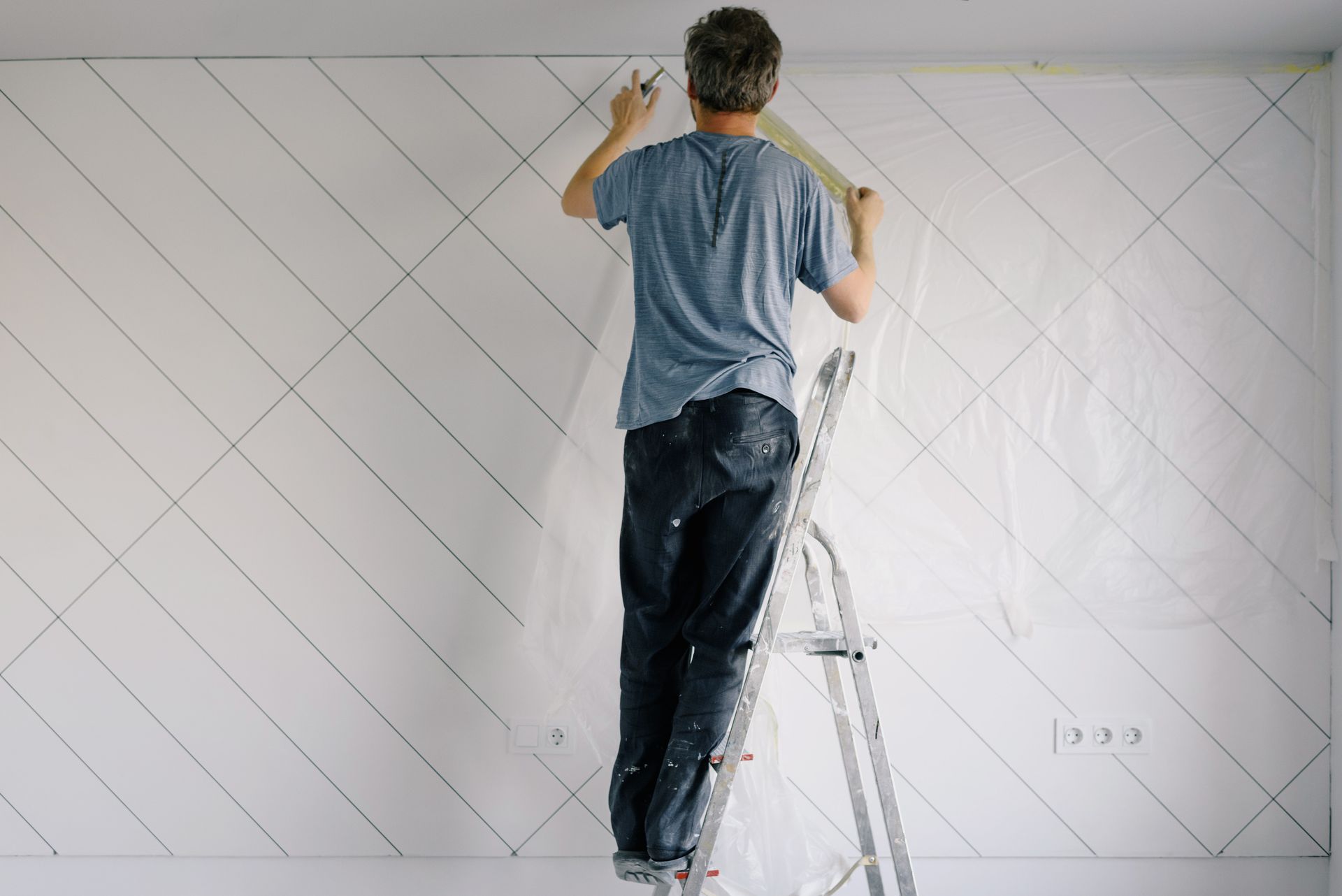 Painter carefully applying paint to an interior wall